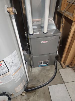 Lennox furnace and water heater installed in a basement mechanical room